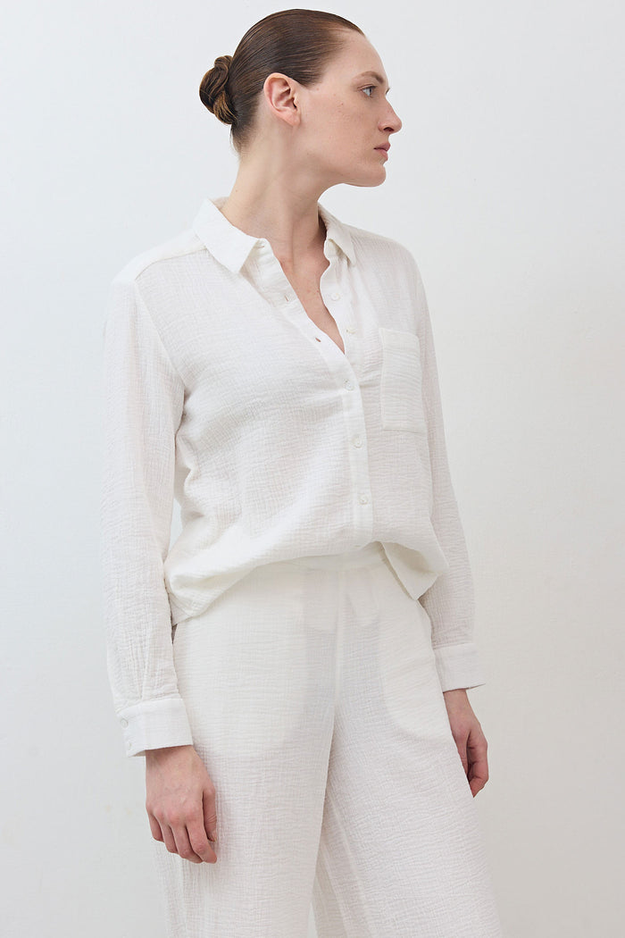 Airy button-down tunic in off-white with long sleeves and collared button front