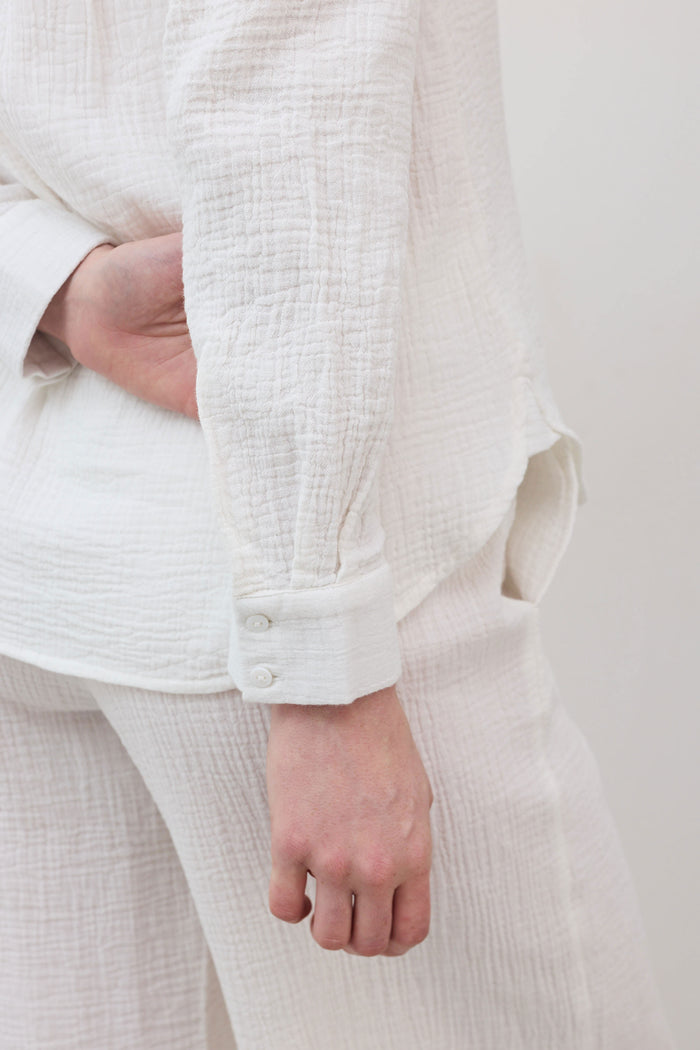 Airy button-down tunic in off-white with button cuff and textured fabric weave