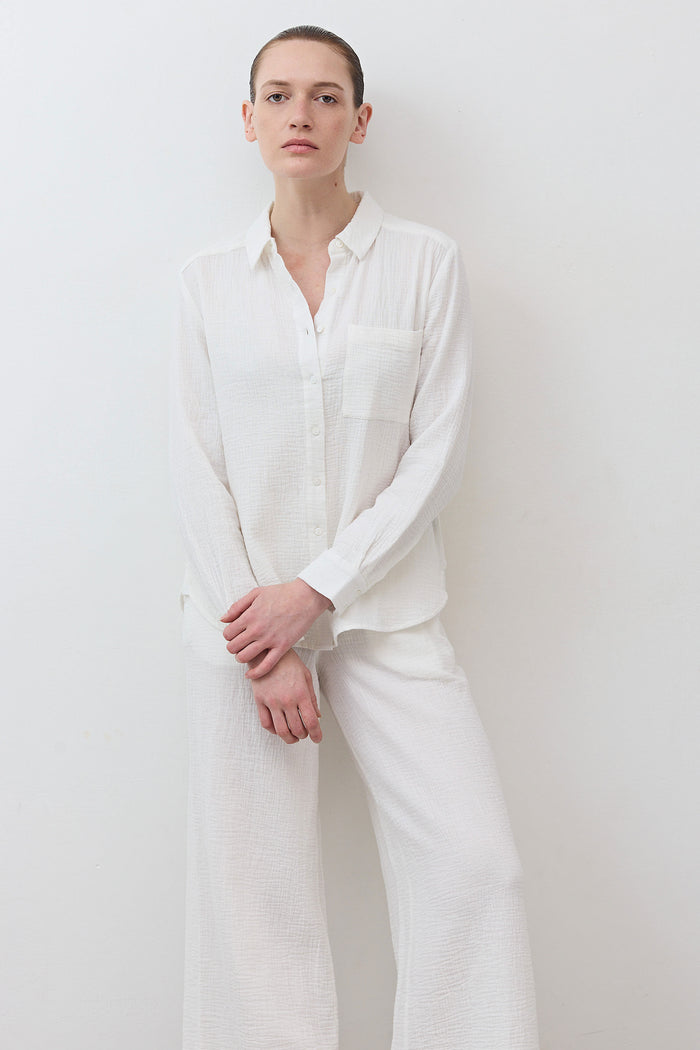 Airy button-down tunic in off-white with chest pocket and long-sleeve button front