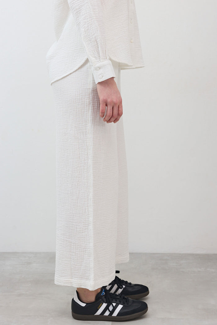 Marshmallow wide-leg pants showing side view, textured fabric with straight wide leg