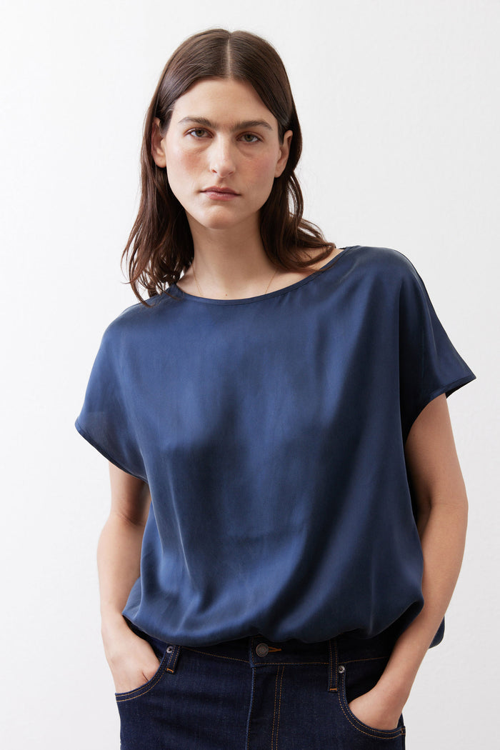 Sky blue silk blouse with crew neck and short sleeves, soft drape