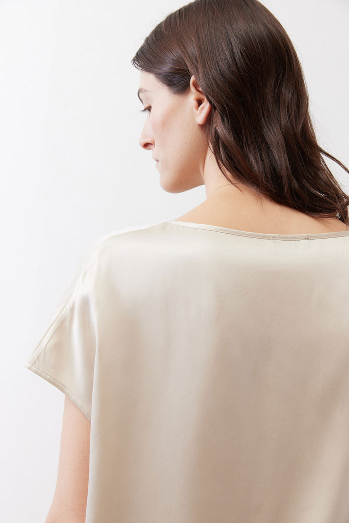 Light cream silk blouse close-up of back neckline and shoulder