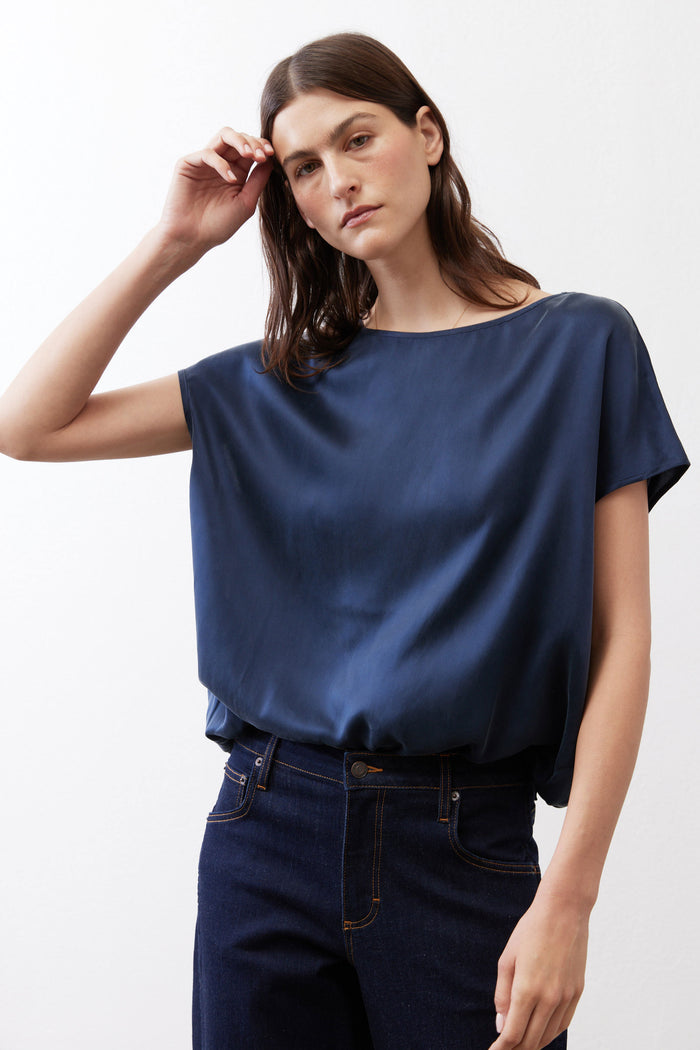 Sky blue silk blouse with crew neck and short sleeves, relaxed draped silhouette