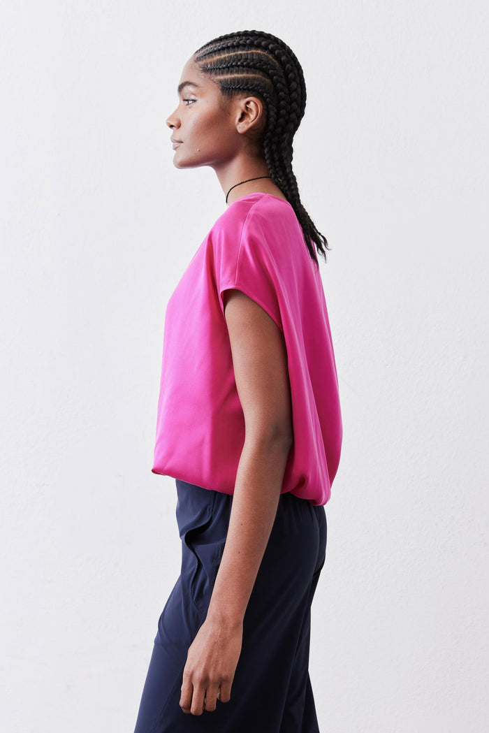 Fuchsia silk blouse with short sleeves and relaxed fit, side view