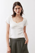 Ivory short-sleeve top with dipped neckline and subtle center ruching