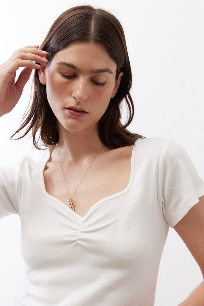 Ivory short-sleeve top with dipped neckline and ruched bust detail