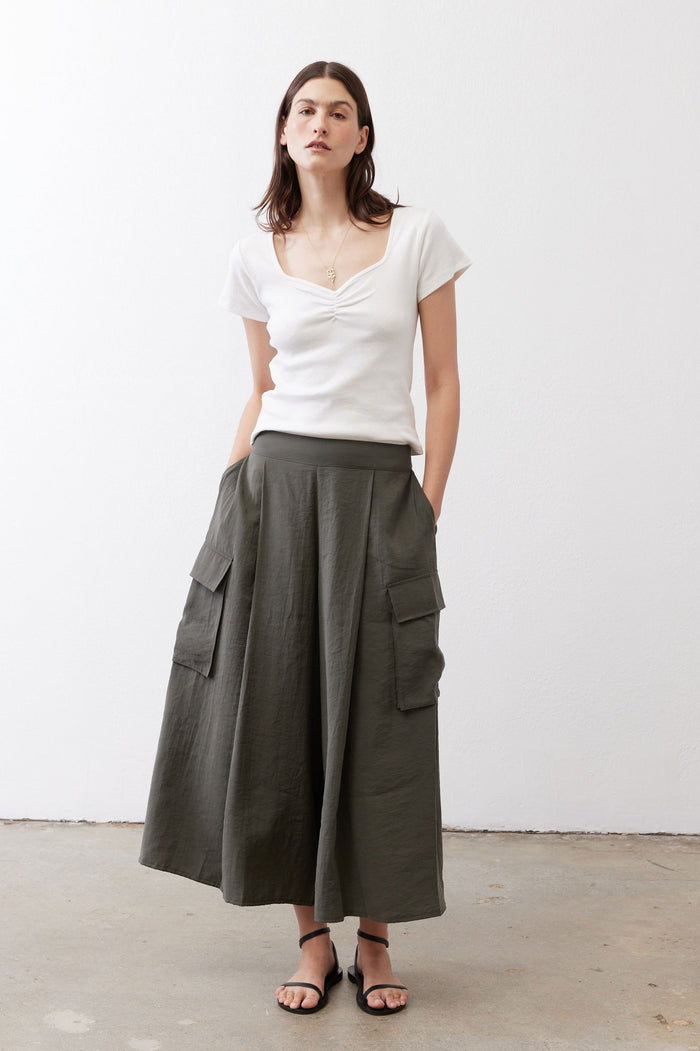 Dark green cargo skirt pants, midi length, wide leg silhouette with side pockets