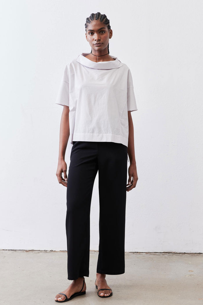 White dolman drape-neck top with short sleeves and loose fit