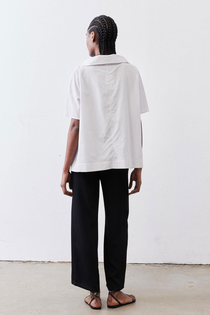 White dolman drape-neck top, back view with hooded drape and short sleeves
