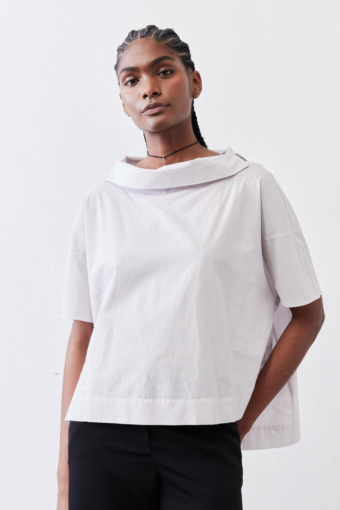 White dolman drape-neck top front view with short sleeves and relaxed fit