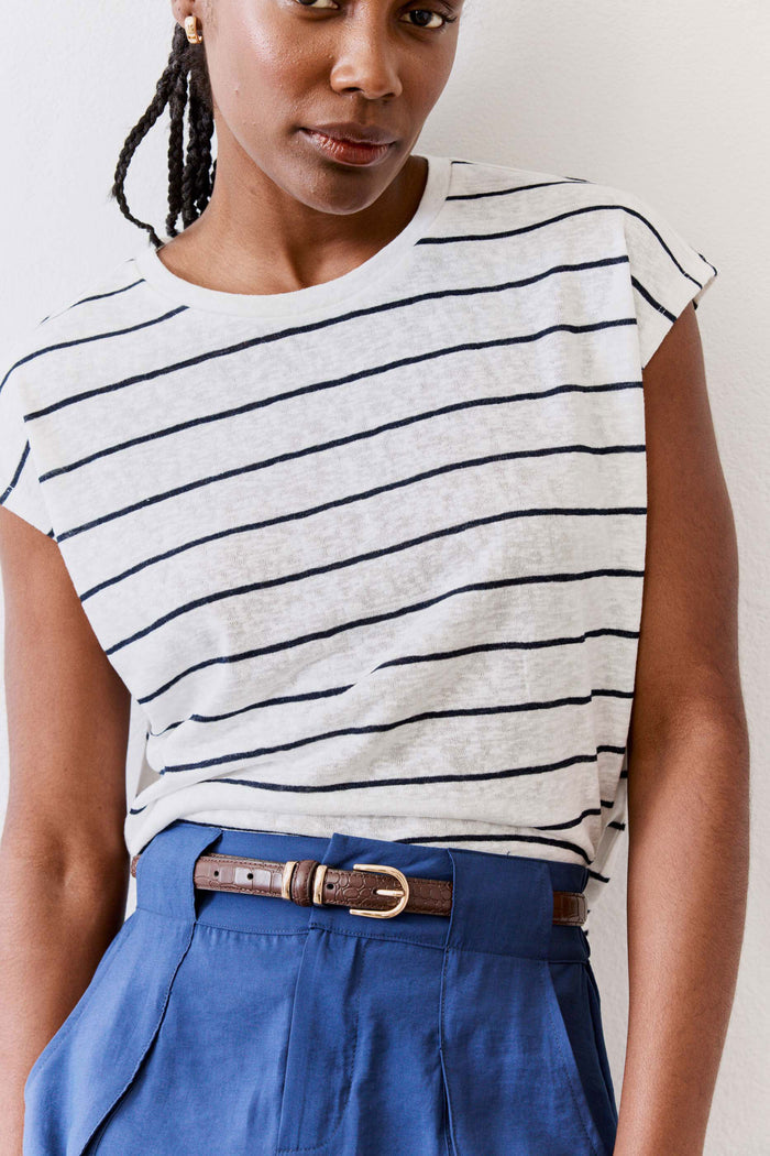 Chocolate croc-embossed belt with oval buckle on blue skirt-like pants at waist