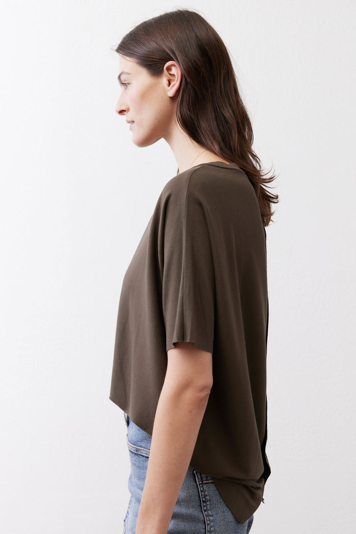 Olive short-sleeve top side view with relaxed drape and loose shoulder