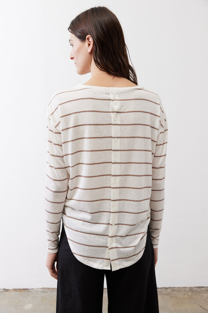 Back of striped long-sleeve top, off-white with tan and red stripes and button detail.