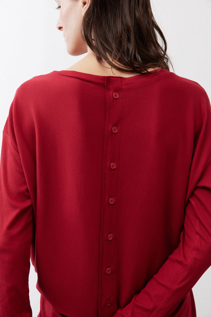 Garnet red long-sleeve top, back neckline close-up with vertical button placket