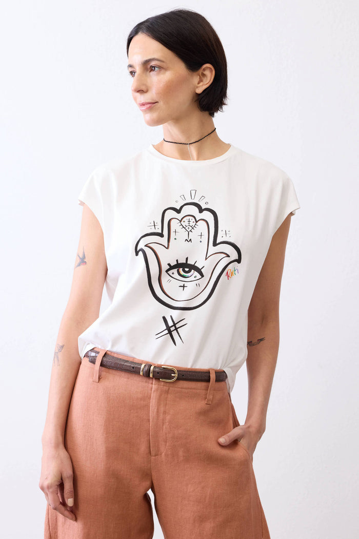 White tee with large Hamsa hand-eye illustration on the back