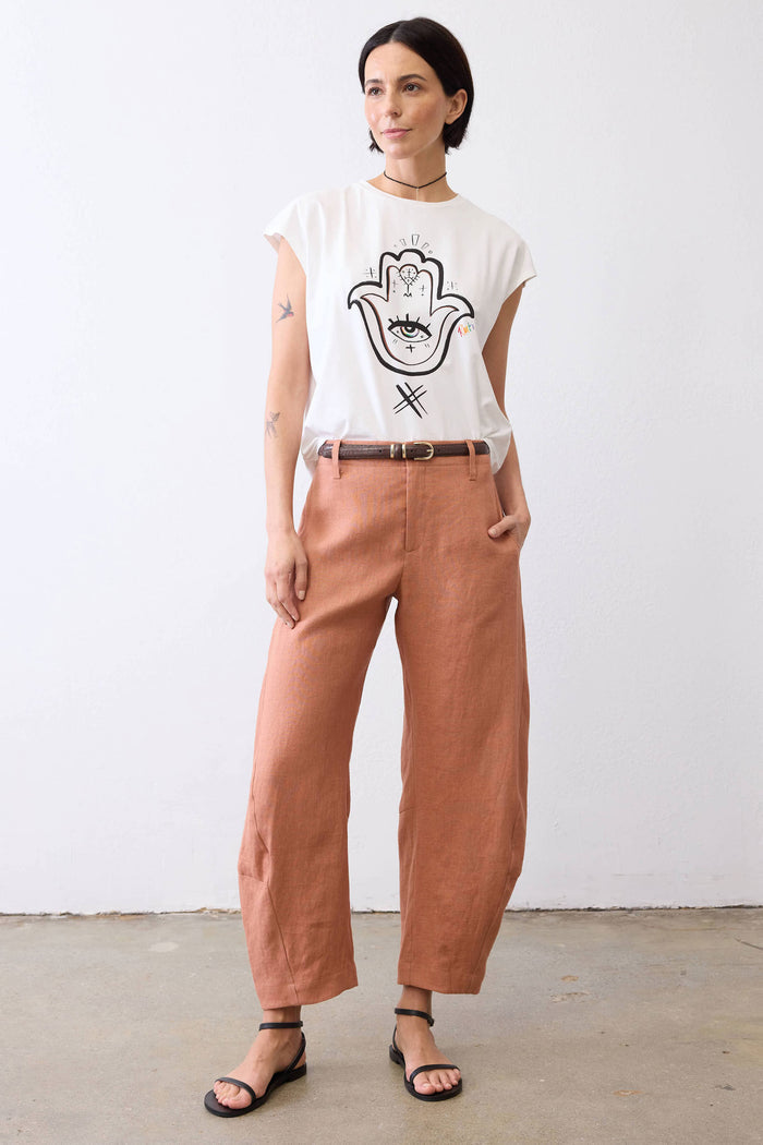 White graphic tee with Hamsa hand-eye design on the front, short sleeves