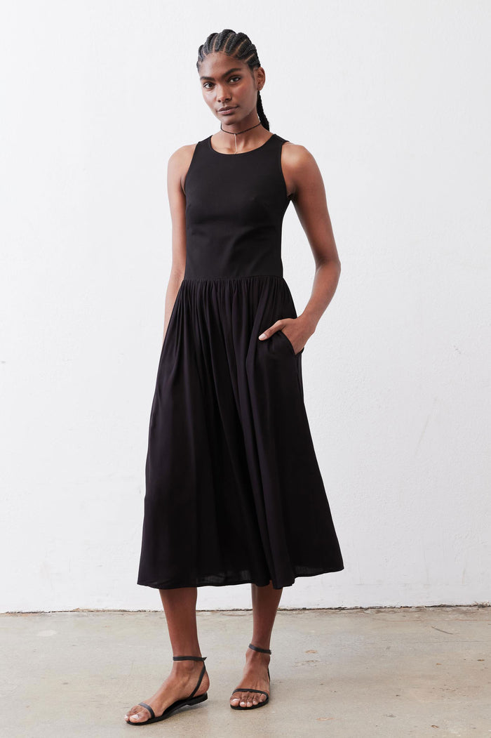 Black high-neck tank dress with gathered skirt, sleeveless midi, front view