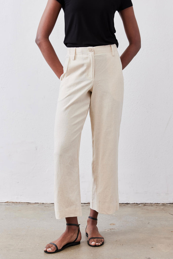 Oat linen A-line pants with relaxed wide-leg fit and high-rise waistband.