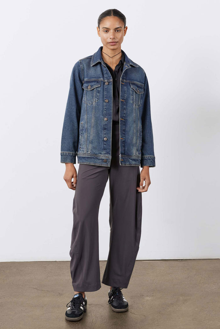 Long line denim jacket, medium-wash blue, button-front, flap chest pockets.