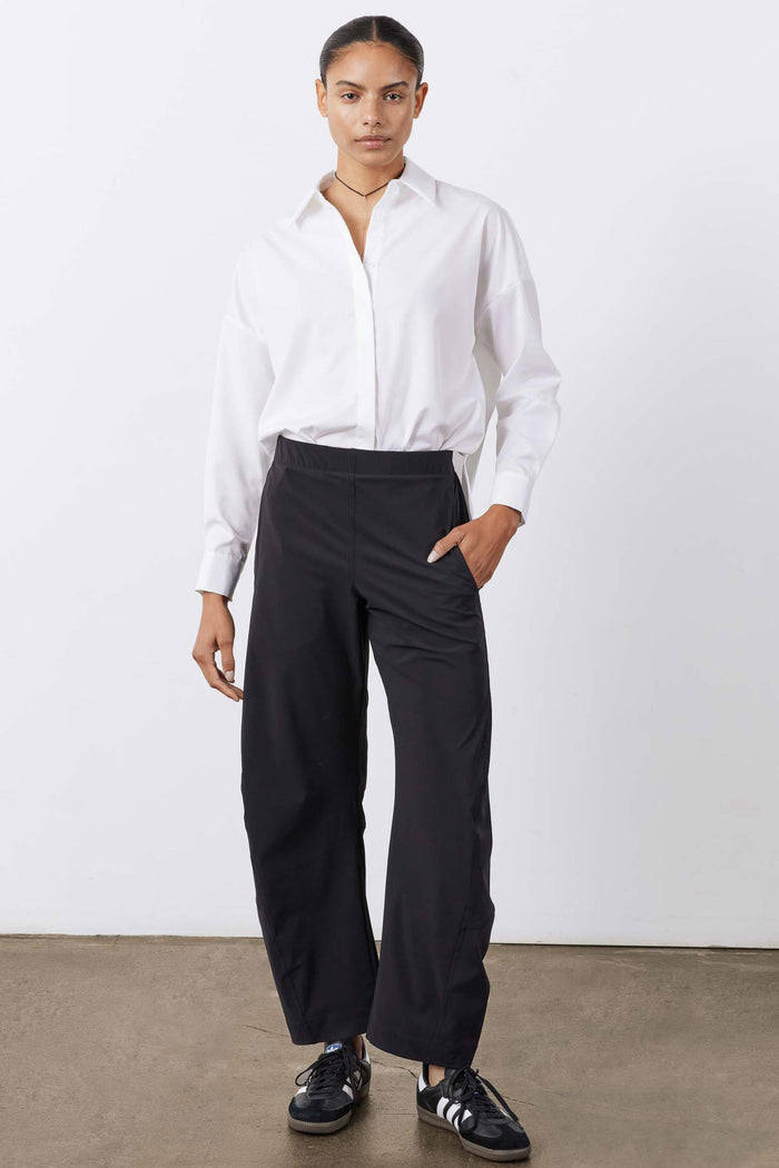 White oversized tunic shirt with relaxed fit, point collar, and long sleeves