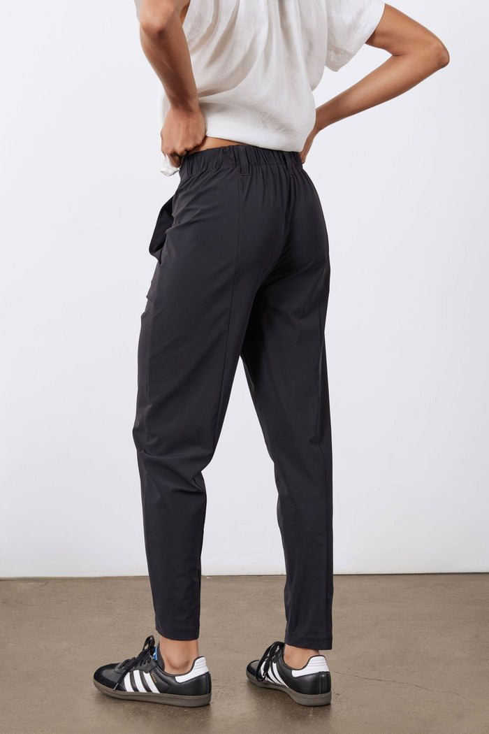 Black tapered pants with flap pocket detail and narrow ankle hem.