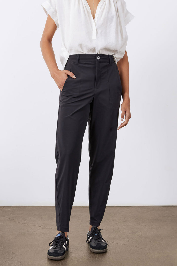 Black tapered pants with front button, belt loops, and angled side pockets.