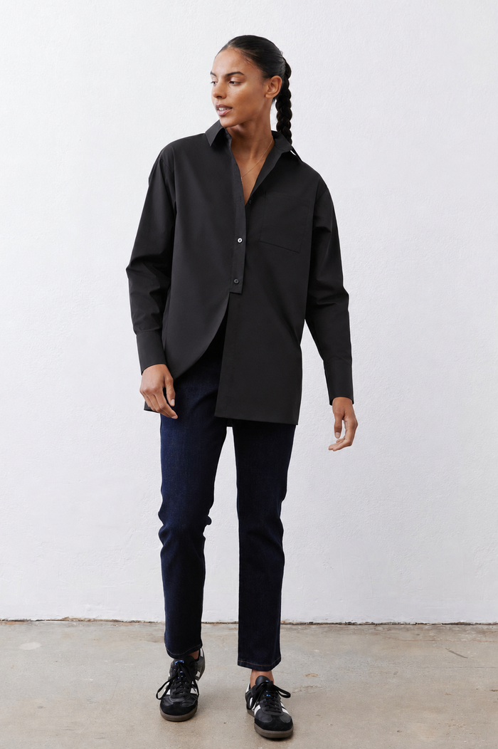 Black asymmetric button-down shirt with chest pocket, pointed collar, long sleeves.