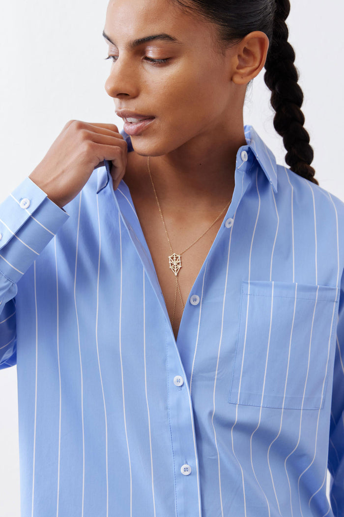 Detail view of light blue striped button-down collar with front buttons