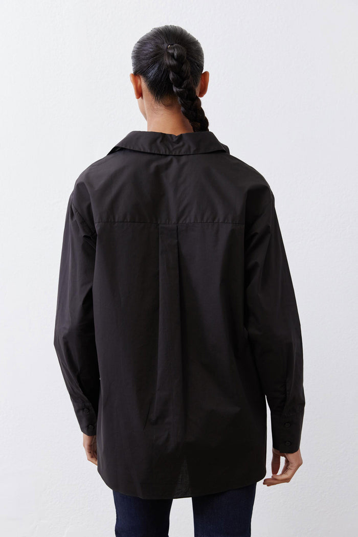 Black asymmetric button-down shirt back with yoke seam and long sleeves