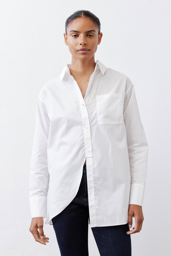 White asymmetric button-down shirt with pointed collar, long sleeves, chest pocket