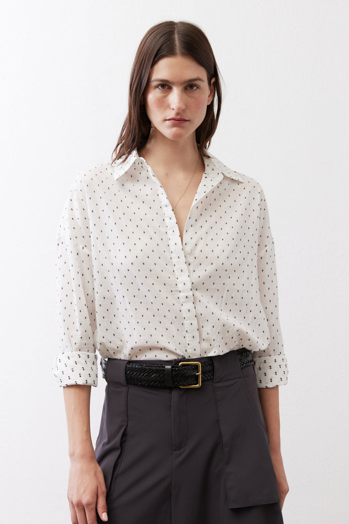 White dot-print oversized tunic with collared neckline and button front, three-quarter sleeves
