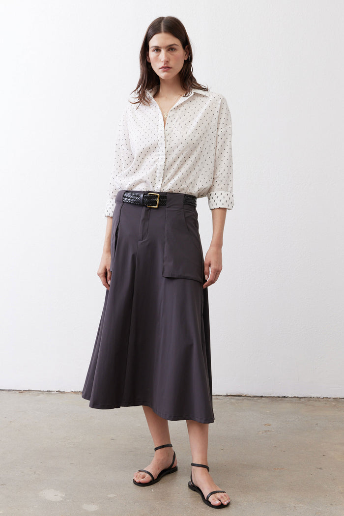 Oversized white tunic with black dot print, button-up front, long sleeves, collared neckline