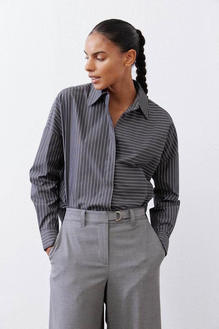 Close-up of gray-and-white striped button-down blouse with button front and collar