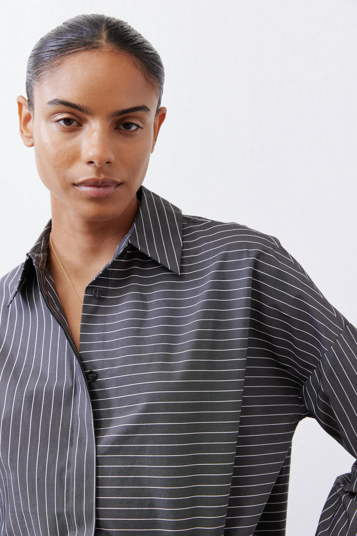 Close-up of gray-and-white striped button-down blouse with pointed collar