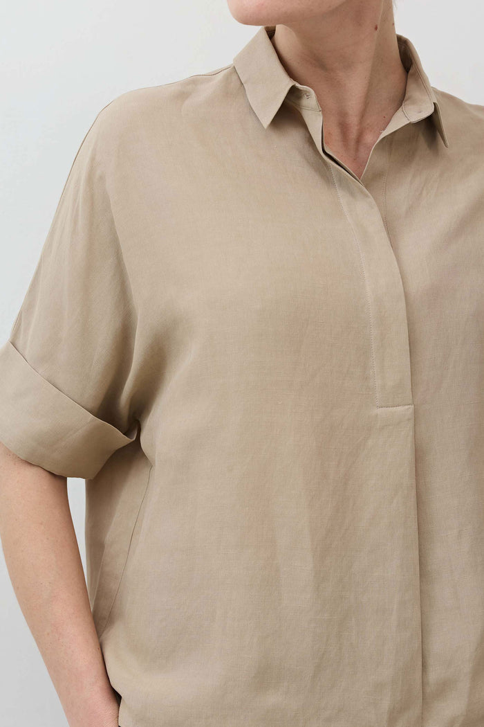 Feather gray oversized blouse close-up with collared neckline and short sleeves