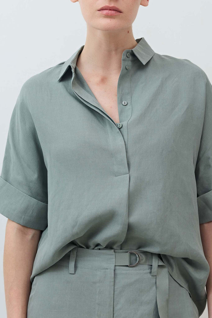 Chinois green blouse close-up: point collar, button placket, half sleeves