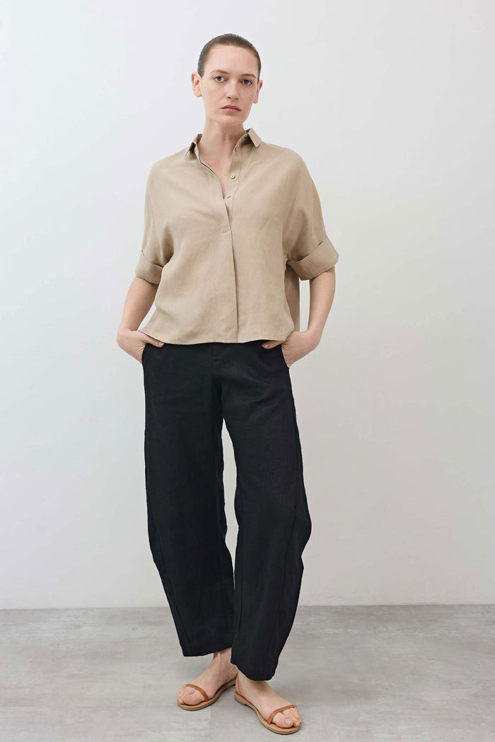 Black linen loose pants full-body view with relaxed wide-leg drape