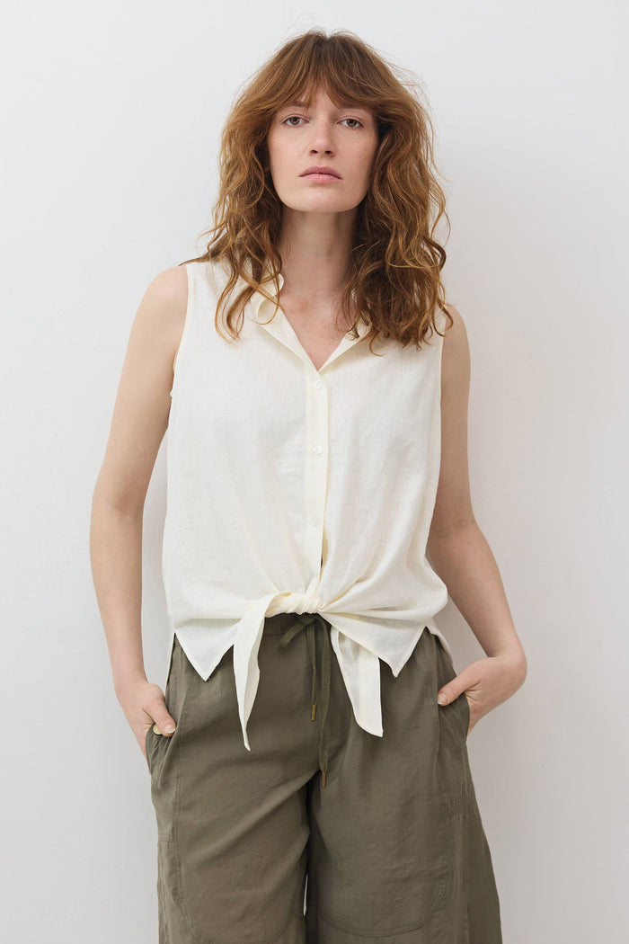 Ivory sleeveless tie-front button-down shirt shown front-on with gathered tied hem