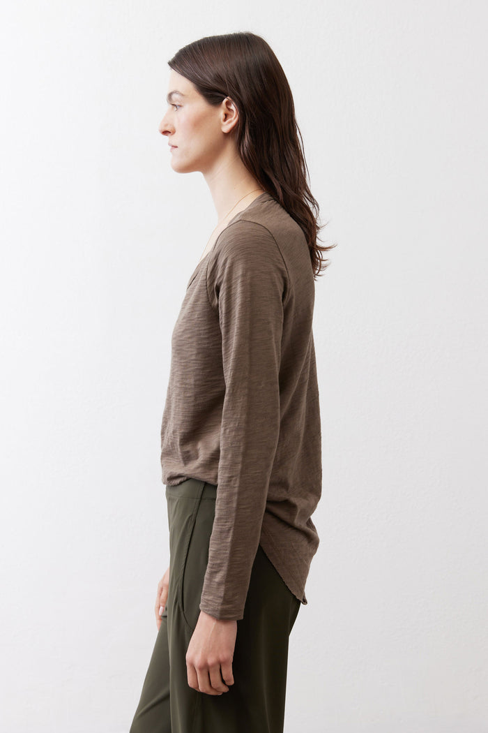 Taupe long-sleeve V-neck top, side view, relaxed swing hem