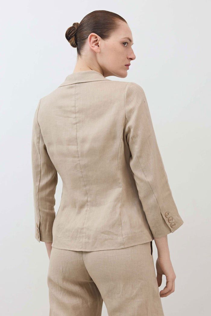 Back view cropped tulip-hem blazer in light beige, single button closure at hem