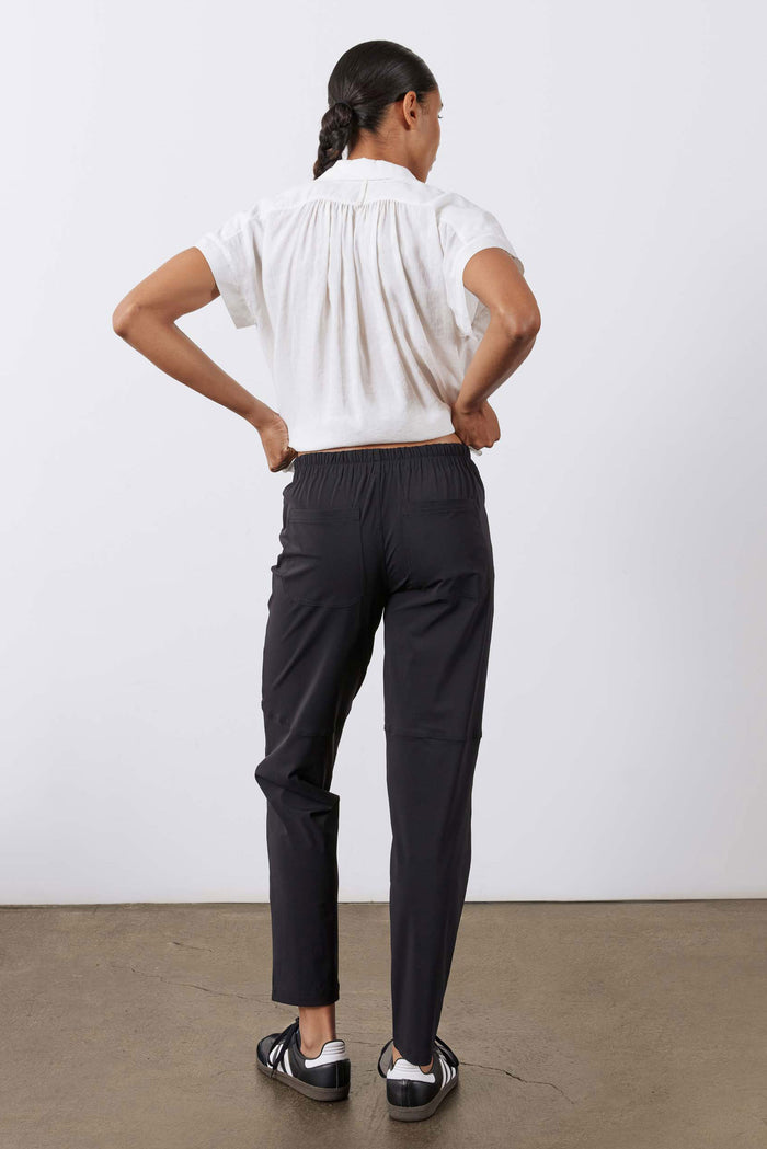 Black slim pants with cargo-style side pockets and tapered legs