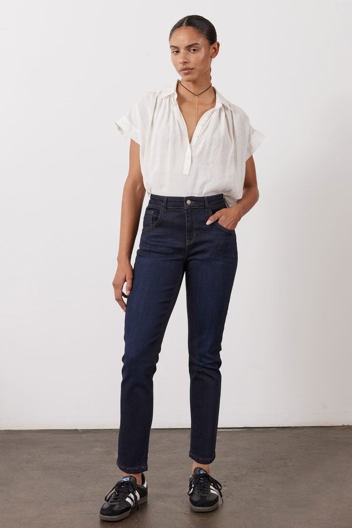 Dark blue fitted jeans, mid-rise with straight slim legs and ankle-length hem