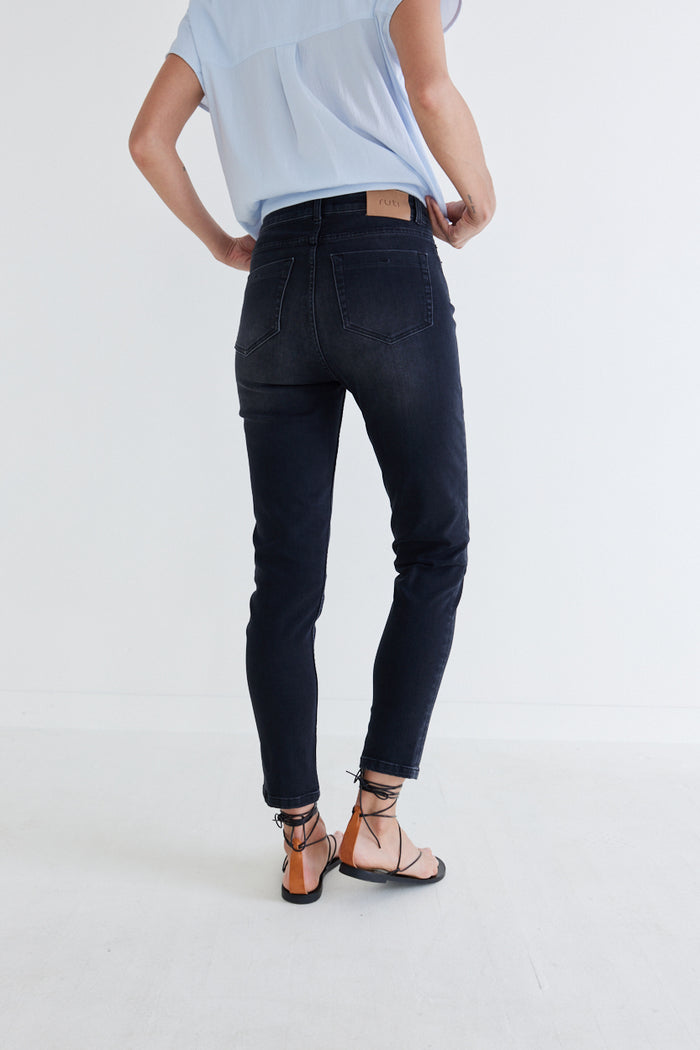 Washed black fitted jeans from back, mid-rise with belt loops