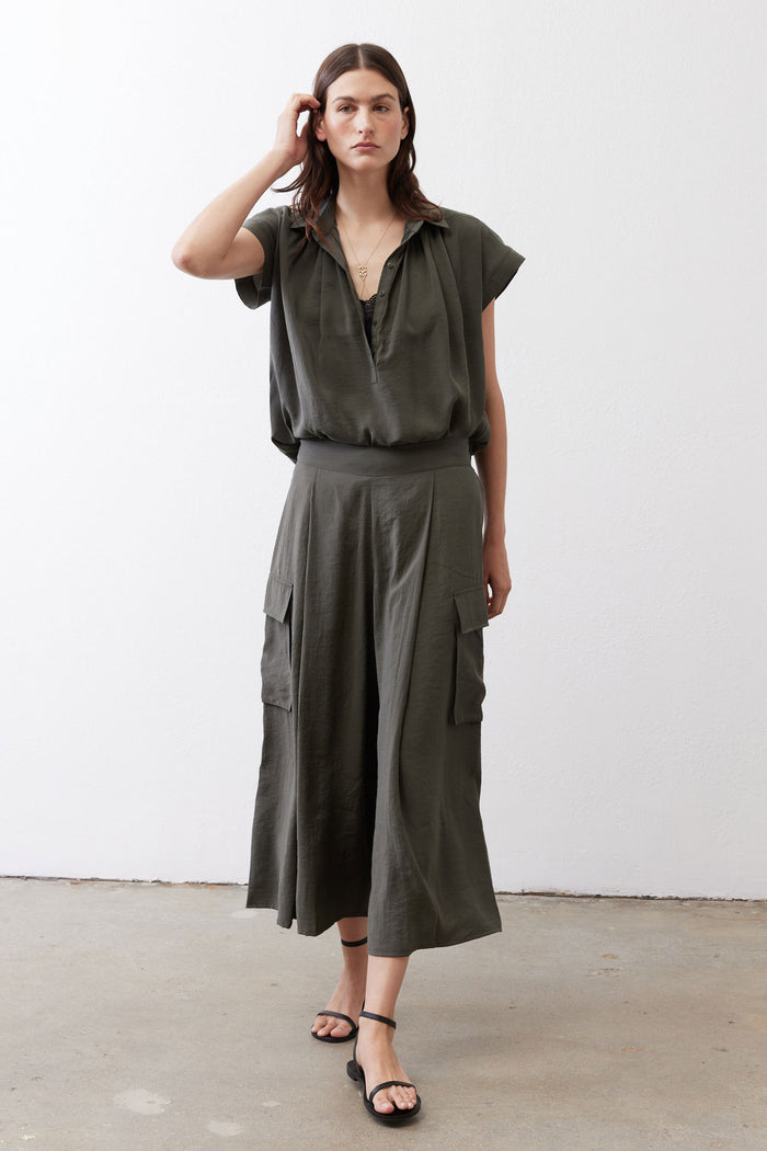 Oversized dark olive voile blouse with short sleeves, V-neck, and button front