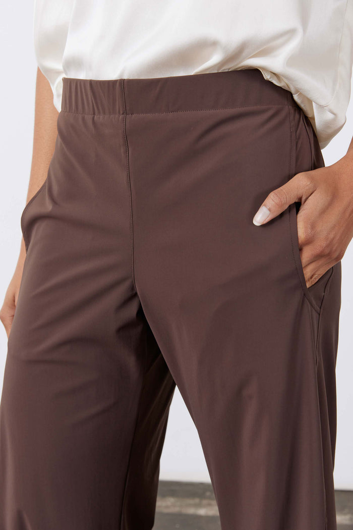 Coffee-brown work pants close-up of front panel and slanted side pocket opening