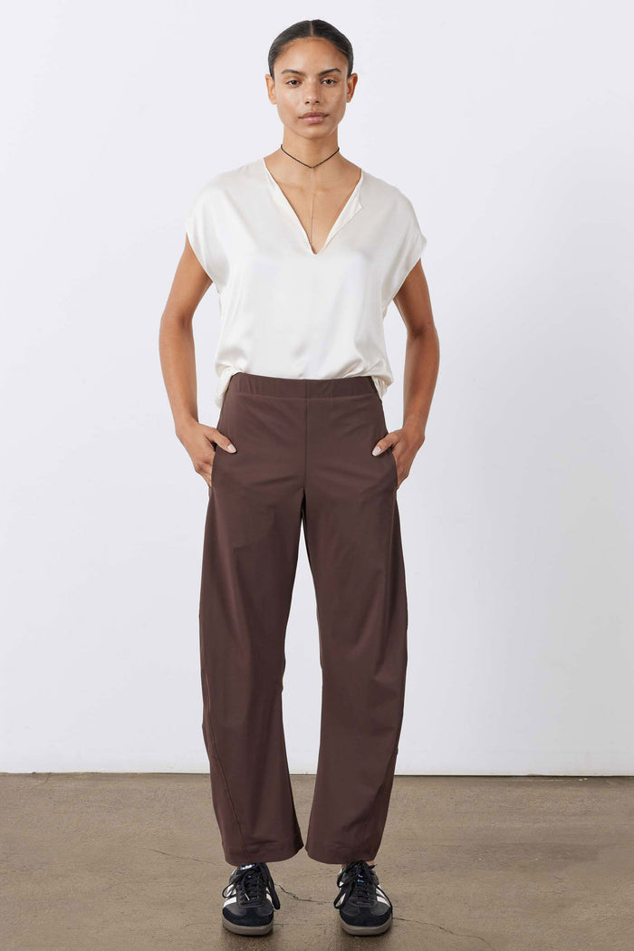 Coffee-brown relaxed work pants with elastic waist, side pockets, and wide legs