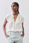 Cream silk blouse with V-neck button front and short ruffled sleeves