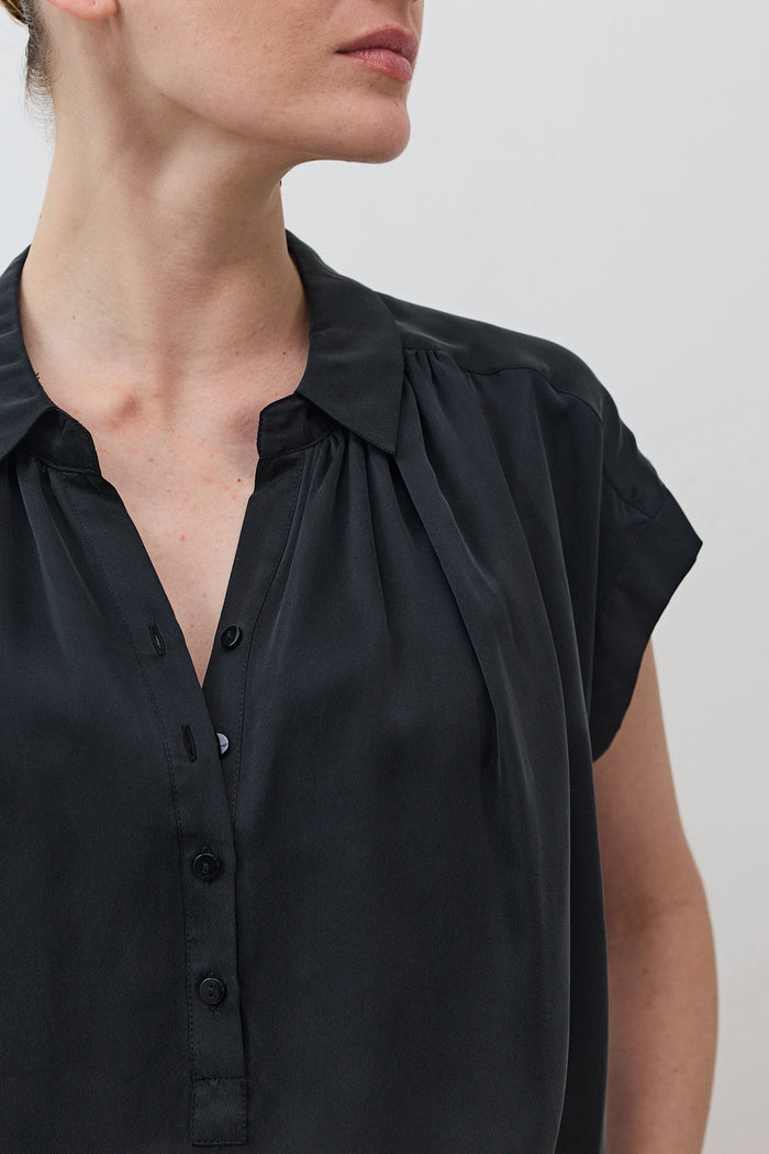 Black silk blouse neckline with button placket and gathered shoulder detail