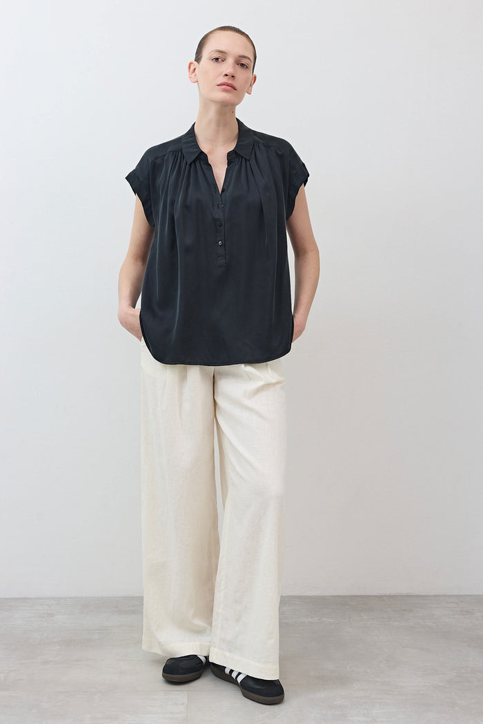 Black oversized silk blouse with short sleeves and button-front placket