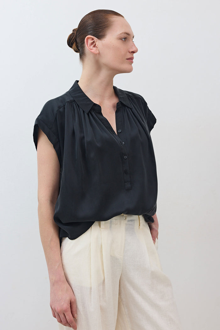 Black oversized silk blouse with draped front and short cap sleeves
